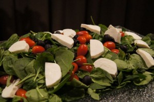 Spinach salad, cherry tomatoes, and fresh mozzarella cheese