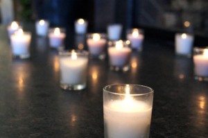 Votive candles on the fireplace hearth
