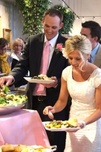 Newlyweds dishing up some delicious food.
