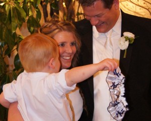 bride and groom with baby brother and garter