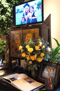 Sign in table with large screen TV for DVD of wedding couple.