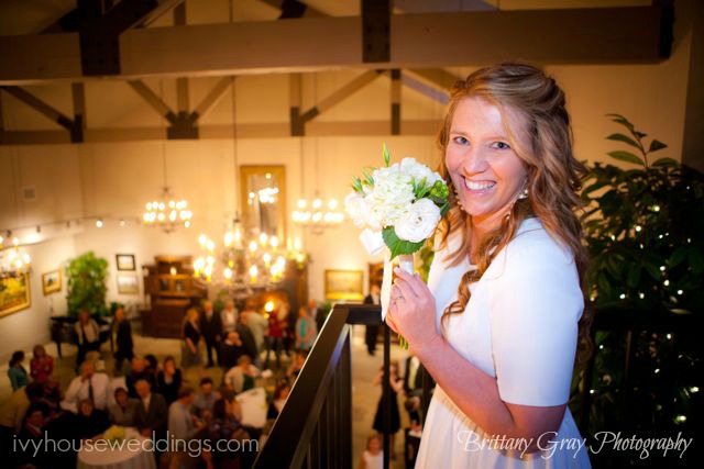 bride on balcony at salt lake city wedding venues ready to throw bouquet